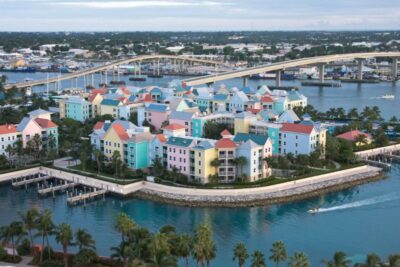 A view of Paradise Island across the bridge from Nassau in The Bahamas with the blue waters surrounding a colorful condominium complex
