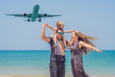 happy family on the beach and landing aircraft traveling
